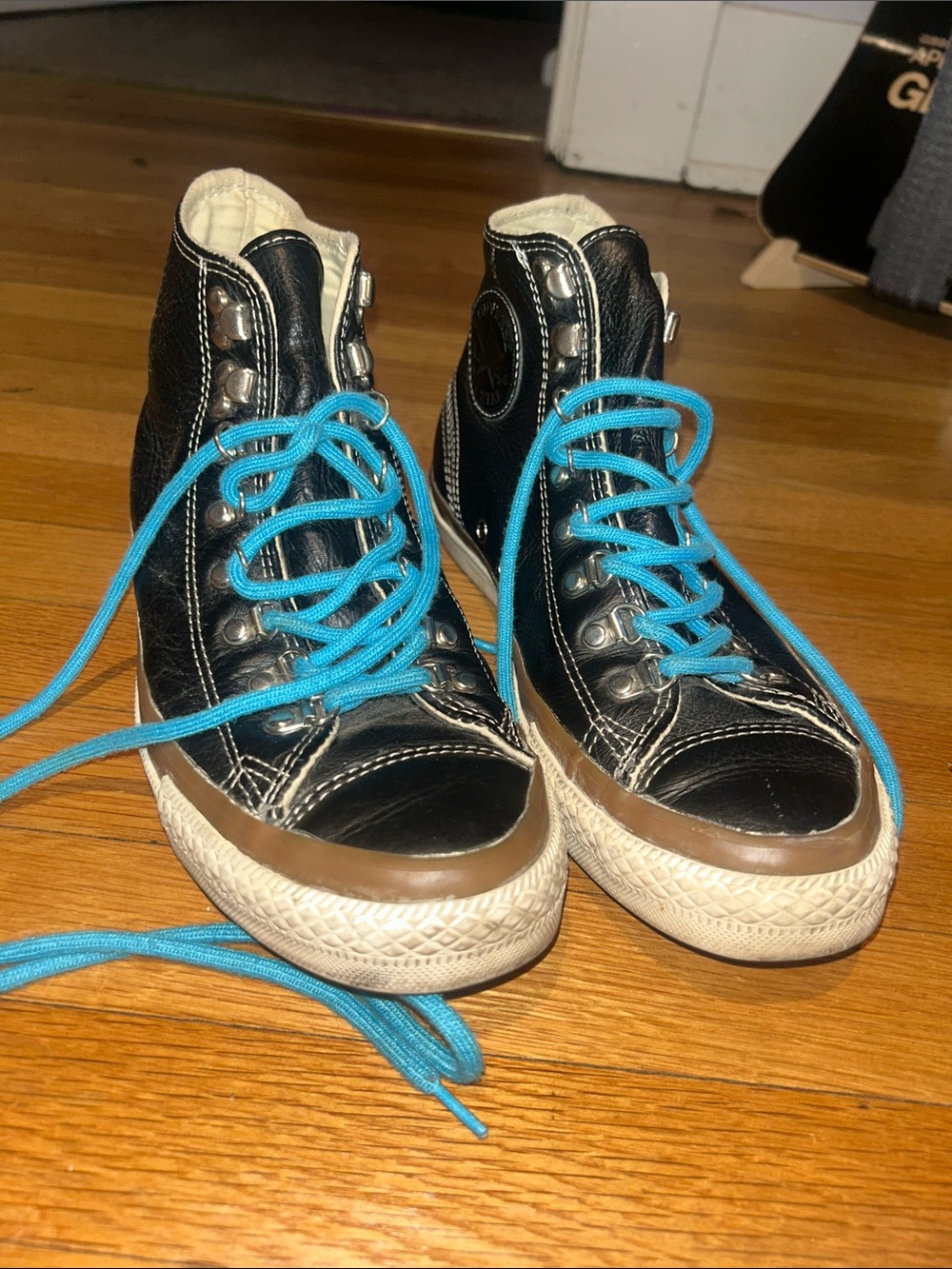 Converse Black Leather Hi Tops with chunky blue laces